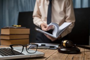 Business Lawyer Working Hard At Office Desk Workplace With Book And Documents. skills