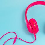 Pink Headphone Isolate On Blue Background.