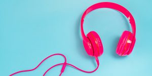 Pink Headphone Isolate On Blue Background.
