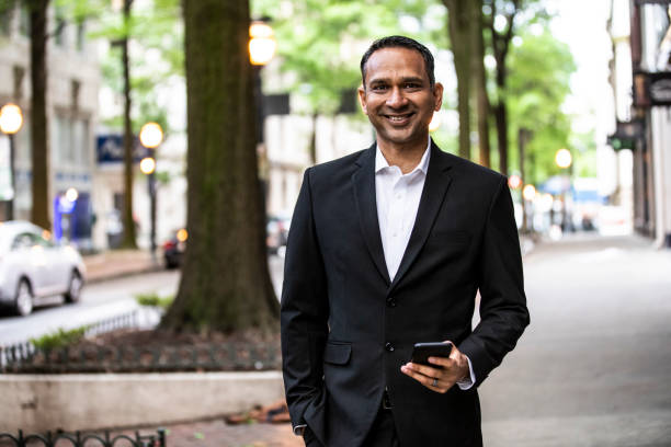 Portrait Of Businessman Using Smartphone In Downtown Area