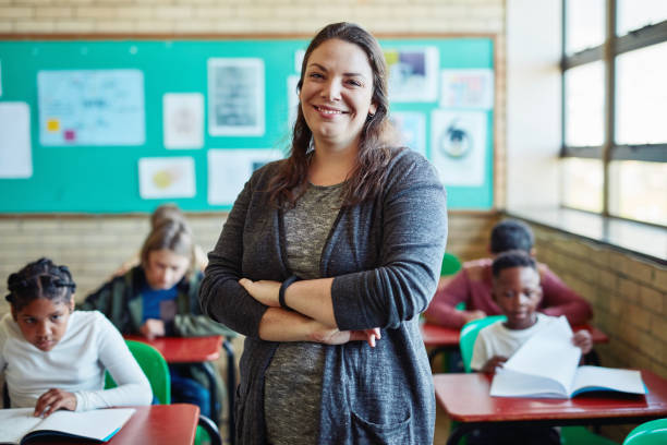 Shot Of A Confident Young Woman Teaching A Class Of Young Children At School