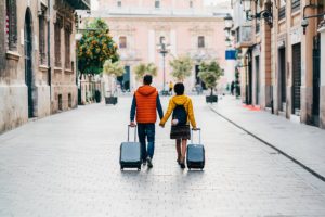 Young Couple With Suitcases Just Arriving In Valencia