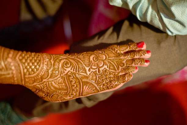 Henna Is Applied To The Legs Of A Beautiful Hindu Bride On Her Wedding.